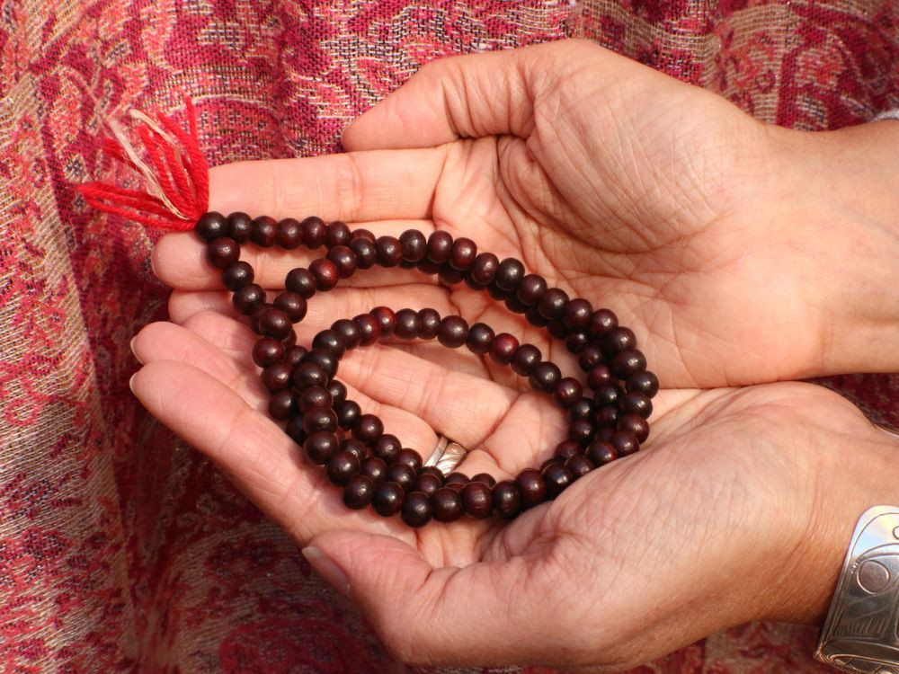 hands holding prayer beads