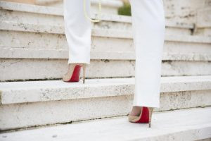A person wearing high heels walking up stairsDescription automatically generated