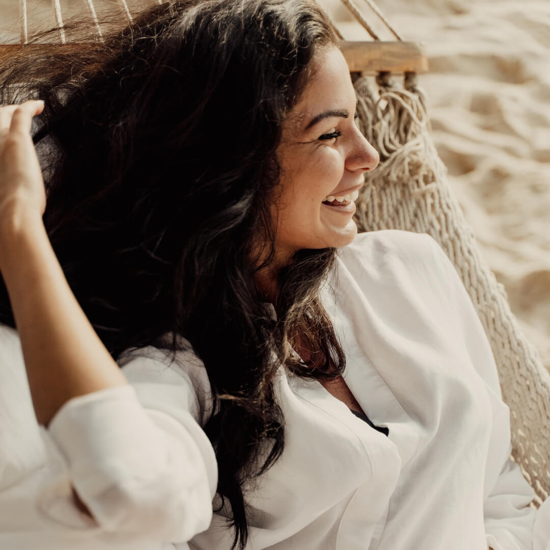  Smiling relaxed woman in a hammock, symbolising freedom, joy, and designing a life you love with support from Hana Zawodny, Brisbane hypnotherapist and menopause coach.
