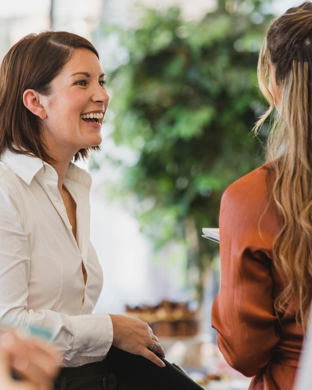  Professional woman in conversation, representing connection and support during burnout and emotional overload