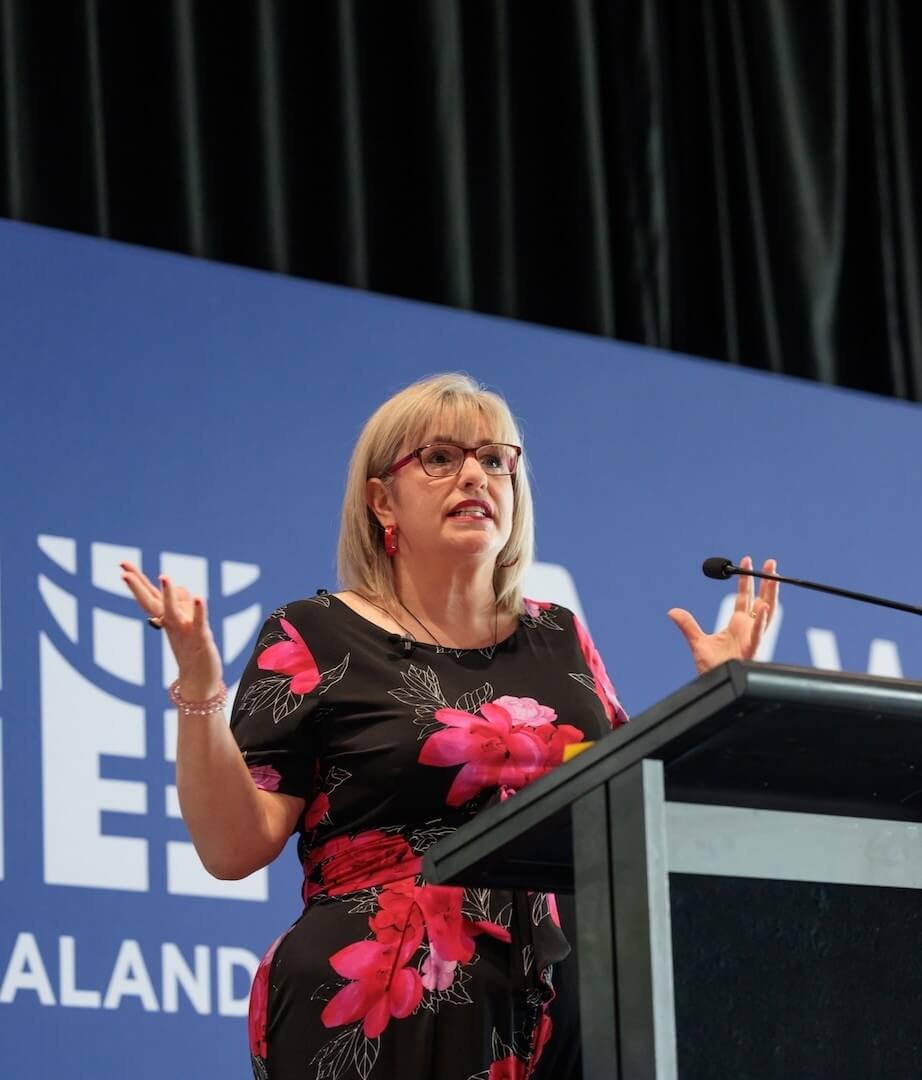  Clinical hypnotherapist and menopause coach speaking on stage, sharing insights on women’s wellbeing and emotional health.