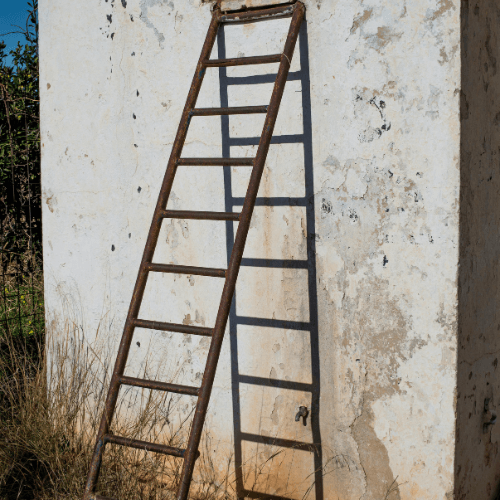 Ladder against a damaged wall