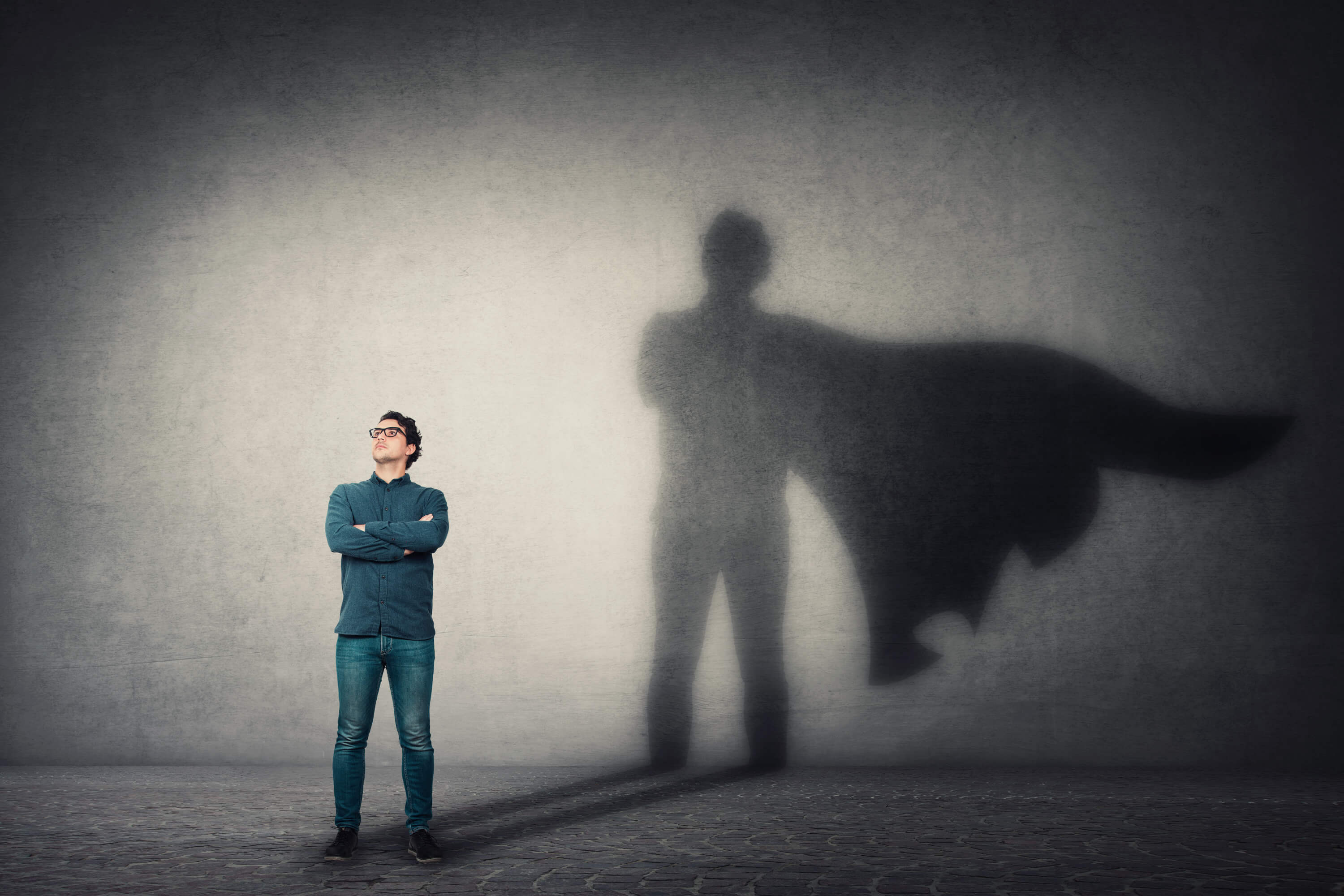 Image of a business man casting a shadow with a cape