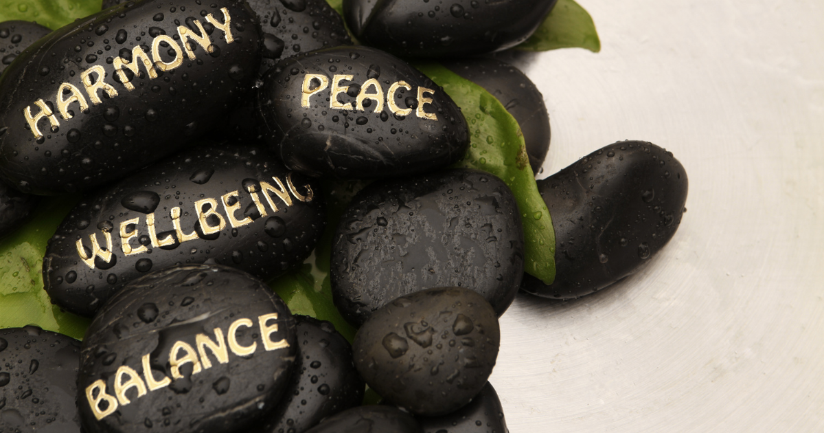 Black smooth stones with positive words